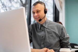 man working call center with headphones computer